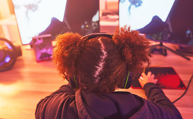 Image showing Back of girl, gamer and video game on computer in home, desk or online games of virtual competition. Female streamer, live streaming and gaming with headphones in neon lighting, esports tech or gen z