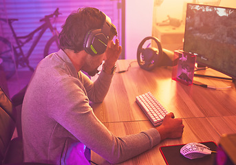 Image showing Headache, gamer or man on computer with depression from loss, fail or online competition tournament anxiety in room. Neon, sad or male stress for gaming mental health, live stream or esport glitch