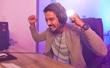 Image showing Winner, achievement or man gamer on computer with microphone celebrating game win and success fist. Happy, cheering or esport player celebration for online competition, excited on gaming progress