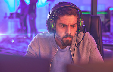Image showing Video game, focus man and esports of online games, virtual competition and face in dark room. Gamer guy, online gaming and live streaming on headset in neon lighting, tech and cyber streamer at night