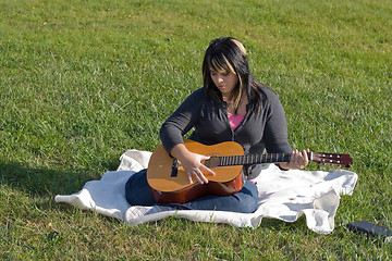 Image showing Girl Playing a Guitar