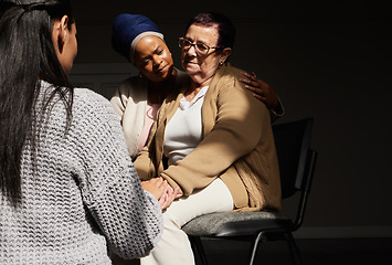 Image showing Support, holding hands and senior woman in group therapy with women understanding, sharing feelings and talking in session. Mental health, grief or depression, people with therapist sitting together.
