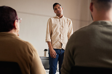 Image showing Support, man standing and introduction to group therapy, help, advice in sharing feelings and talking in session. Mental health, grief or depression, men and women listening to therapist and together