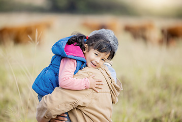 Image showing Grandmother carrying girl, field portrait and family farm, grass and bonding together with love outdoor. Old woman, child and hug support in countryside, care and happiness in nature with landscape
