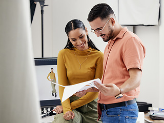 Image showing Documents, collaboration or photoshoot with a photographer and model in a studio for creative production. Teamwork, designer or fashion with a designer man and woman at work on a magazine shoot