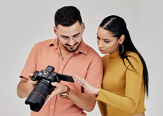 Image showing Teamwork, photographer and startup with camera in studio for shoot, magazine project or online content review. Digital agency, collaboration or people working on marketing or advertising campaign