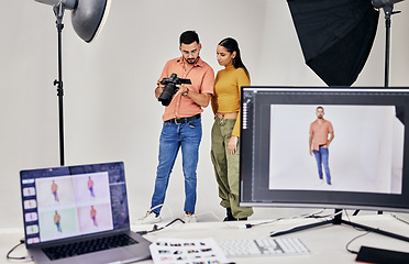 Image showing Collaboration, photographer and startup people in studio set with camera for shoot, magazine project or online content. Planning or teamwork examine picture for digital catalog or fashion web design