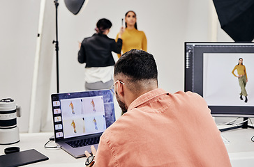 Image showing Laptop, photography editor and model in studio with photographer and shooting fashion design magazine cover or content. Creative, tech or startup people in collaboration, teamwork or makeup backstage