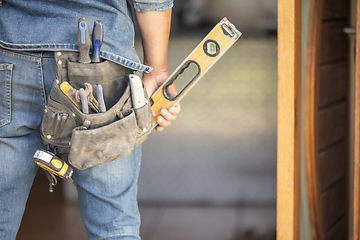 Image showing Maintenance man, bag and tools with hands, front door and home improvement service in property industry. Construction worker, back and jeans for working at house, building or real estate development