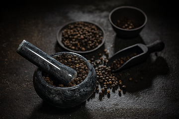 Image showing Marble mortar full of black peppercorns