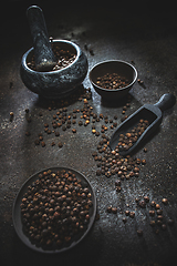 Image showing Black peppercorns spilled out of a scoop