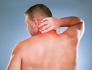 Image showing Back, senior man and neck pain with stress, emergency and guy against blue studio background. Mature male, gentleman and injury with muscle strain, tension and burnout with first aid and suffering
