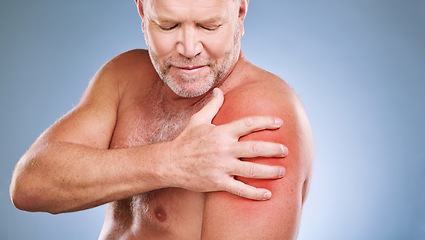 Image showing Senior man, arm pain and red glow on muscle or body on a blue background in studio with arthritis. Elderly model person with hand on injury, anatomy health problem or broken bone medical risk