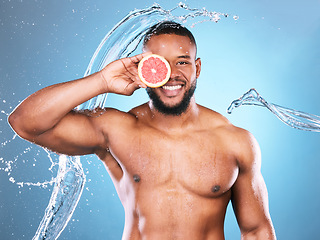 Image showing Portrait, water splash or black man with grapefruit for skincare facial cleaning with vitamin c benefits in studio. Happy smile, healthy or young male beauty model with a glowing face for wellness