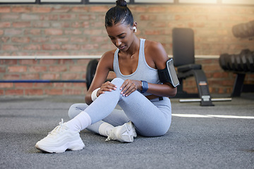 Image showing Fitness, injury or sports woman with knee pain after exercising, body training accident in workout. Red glow, floor or injured Indian girl suffering from muscle tendon after legs exercise at gym club