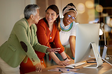 Image showing Collaboration, communication and a business woman with her team, working on a computer in the office at night. Teamwork, diversity and coaching with a senior female manager training her staff at work