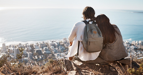 Image showing Couple, travel and cityscape with ocean view for peace and calm while hiking with a backpack. Man and woman together on vacation in nature with love, care and support with a hug outdoor on mountain