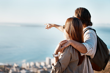 Image showing Travel, pointing and hiking with couple on mountains with mockup for adventure, relax and summer. Fitness, nature and ocean view with man and woman hugging for affectionate, bonding and vacation