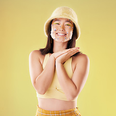 Image showing Asian woman, gen z fashion and studio portrait with beauty, eyes sticker art and retro aesthetic by yellow background. Young Japanese model, excited face and vintage 90s clothes with facial makeup