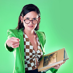 Image showing Angry, pointing and books with portrait of woman and teaching for study, learning and education. Mad, review and problem with annoyed teacher in green background studio for strict, failure and wrong