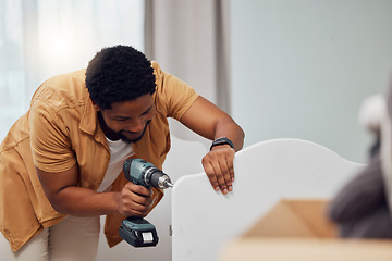 Image showing DIY, drill and crib with a black man in his house to build furniture in the baby bedroom or nursery. Family home, handyman and cot with a father in a room building a bed for his newborn kid