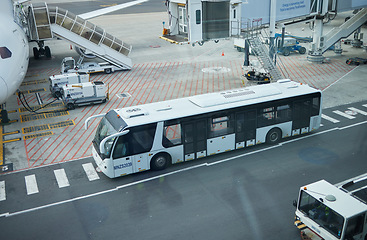 Image showing Airport, bus transport and plane on road, runway and park for travel service, fuel and outdoor. Urban bus stop, street and airplane for transportation, logistics and immigration on international jet