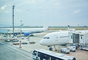 Image showing Airplane, bus or loading luggage on runway for traveling outdoors at worldwide airport for journey. Global, transportation services or commercial aeroplane on ground for international flight cargo