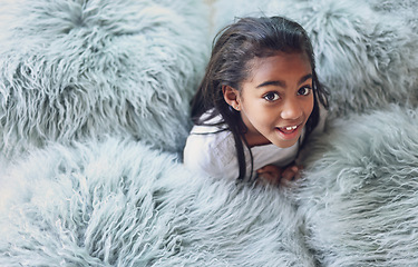 Image showing Relax, happy and portrait of a child with pillows in her modern bedroom in her home. Happiness, smile and girl kid resting, having fun and being playful with fluffy blankets in her room at a house.