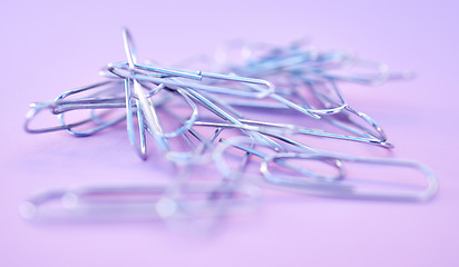 Image showing Paper clips together in pile, connected and a chain on purple background. Office supplies, organization and project management with paperclip for business strategy and planning to organize paperwork.