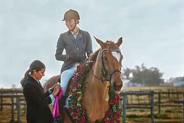 Image showing Woman, horse and winner of equestrian competition with ribbon award for sports achievement. Athlete person on animal for horseback riding, race and training for badge prize with pride in countryside