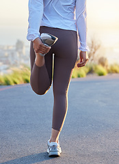 Image showing Fitness, leg and stretching by woman in road for running, training and exercise at sunset, body and warm up. Runner, stretch and rear view of girl at sunrise for cardio, marathon or practice run
