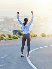 Image showing Run celebration, woman winner and fitness goal of a excited and happy runner on a road. Cityscape, freedom and motivation of a female athlete back feeling exercise success from running and training