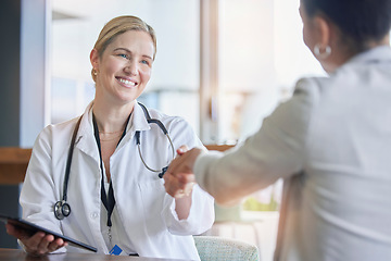 Image showing Handshake, healthcare or trust with a doctor woman and patient in a hospital for a checkup or diagnosis. Medical, wellness and insurance with a medicine professional shaking hands to say thank you