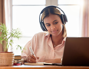 Image showing Woman, student with laptop and headphones, writing notes in notebook, education and elearning with study notes. Mexican female, internet with wifi and tech, online class with webinar and studying