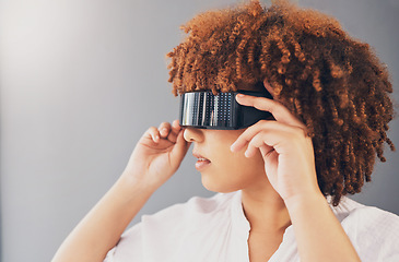 Image showing Futuristic, glasses and black woman isolated on a gray background for metaverse, cyberpunk and virtual reality. VR sunglasses, digital software and vision of gen z model or person thinking of future