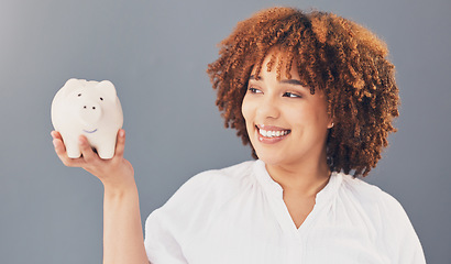 Image showing Happy, piggy bank or black woman with savings budget or financial profits growth on studio background. Smile, finance or African American girl holding financial tin for cash loan or money investment