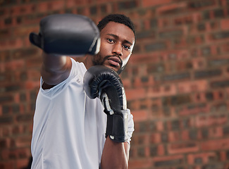 Image showing Fitness, boxing and portrait of a black man in gym doing a intense cardio workout with gloves. Sports, exercise and African male boxer athlete training or practicing for match, fight or competition.