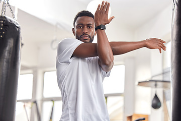 Image showing Stretching, fitness and portrait of a black man at the gym for training, muscle and arms warm up. Exercise, focus and African athlete preparing for a workout, ready for sports and cardio for health