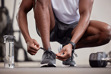 Image showing Hands, fitness and tie shoes in gym to start workout, training or exercise practice. Sports, health and black man or athlete tying sneakers to get ready for exercising, running or cardio for wellness