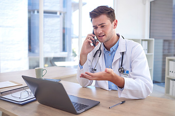 Image showing Man, doctor and phone call with laptop in Telehealth for healthcare consulting, advice or help at office desk. Male medical professional on smartphone by computer explaining medicare or diagnosis