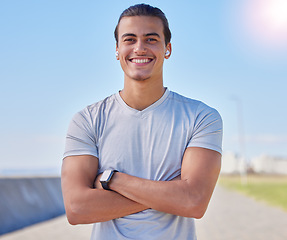 Image showing Fitness, smile and running with portrait of man for health, sports and marathon training. Wellness, workout and exercise with athlete face and arms crossed in outdoors for cardio, jogging and happy
