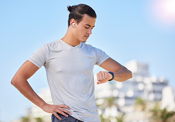 Image showing Exercise, smartwatch and man checking running, health and cardio progress while training in a city. Digital, heart and pulse tracker for guy runner outdoor for performance, monitor and fitness app