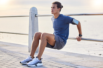 Image showing Fitness, stretching and man at a beach for training, exercise and running at sunset, serious and focus. Mindset, stretch and workout for mexican guy at ocean, competitive and concentration before run