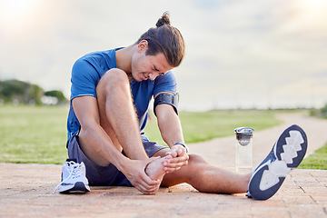 Image showing Fitness, sports injury and foot pain with man in park for muscle spasm, inflammation and joint problem. Running, workout and exercise with athlete and emergency for health, suffering and broken ankle