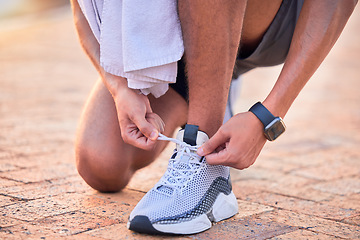Image showing Closeup, outdoor and man with fitness, shoelace and runner with wellness, training and healthy lifestyle. Zoom, male athlete and guy with smartwatch, tying shoes and exercise for workout or endurance