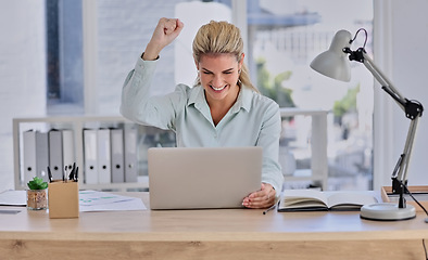 Image showing Woman, laptop and celebration for winning, promotion or reading good news at office desk. Happy female winner by computer raising fist and celebrating win, discount or sale for victory or achievement