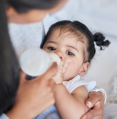 Image showing Baby drinking bottle, formula and nutrition with feeding and family, health and growth with early childhood development. Mother feed infant child milk, people at home with health and wellness