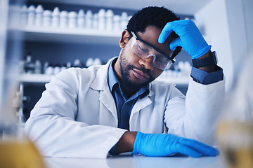 Image showing Burnout, stress and scientist black man with a headache during medical research in a lab or laboratory frustrated and sad. Exhausted, fail and tired professional technician suffering from fatigue