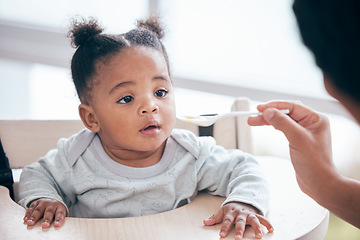 Image showing Food, breakfast and parent feeding a baby in the morning while eating porridge with a mother. Hungry, feed and African child ready to eat a meal, lunch or dinner with a mom in a family home