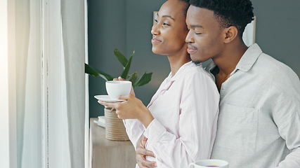 Image showing Black couple, hug and morning coffee while showing love and care and looking out the window to watch the view on honeymoon vacation. Happy black man and woman in a committed and healthy relationship